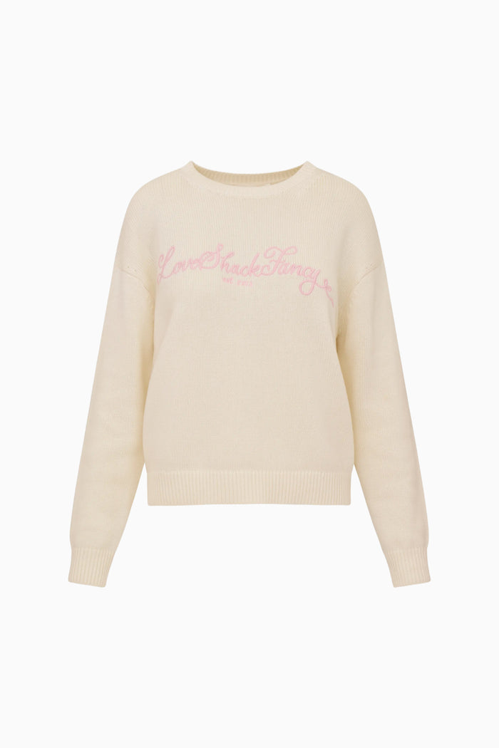Beige sweater with pink LoveShackFancy text on a white background