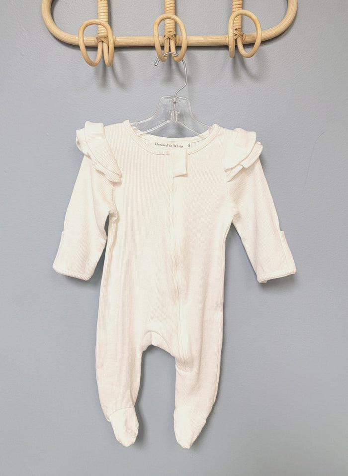 White baby romper with zip front and ruffles.