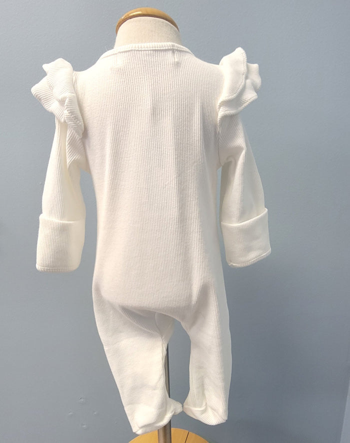White baby romper with zip front and ruffles.