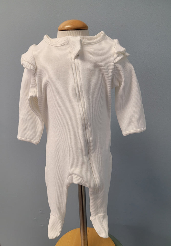 White baby romper with zip front and ruffles.