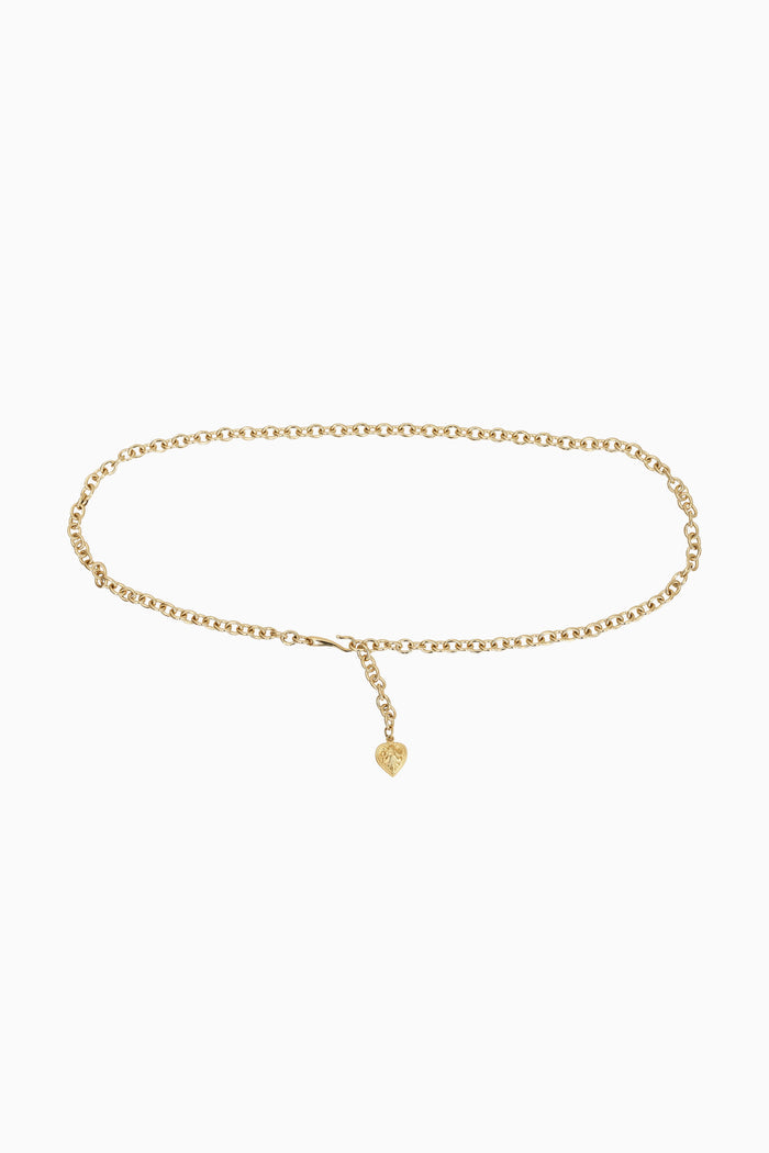 Gold chain belt with a small heart charm on a white background