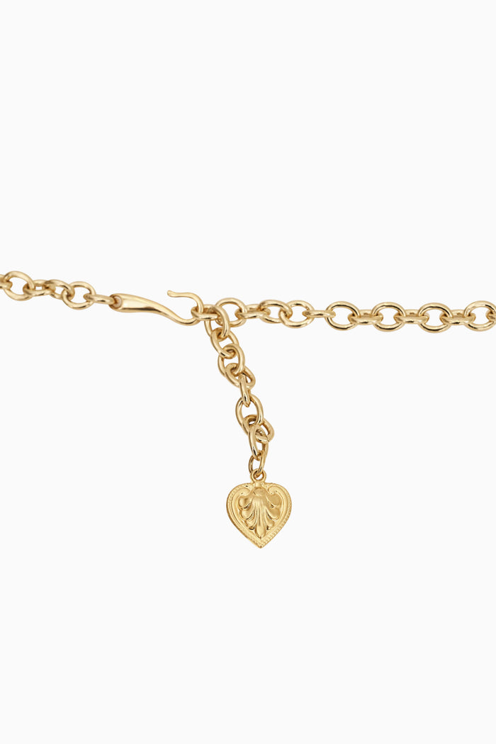 Gold belt with a heart-shaped charm on a white background