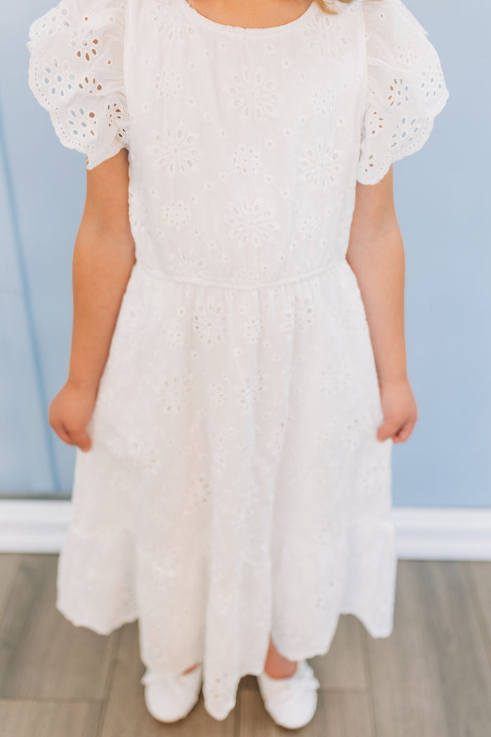 Girl in white eyelet dress