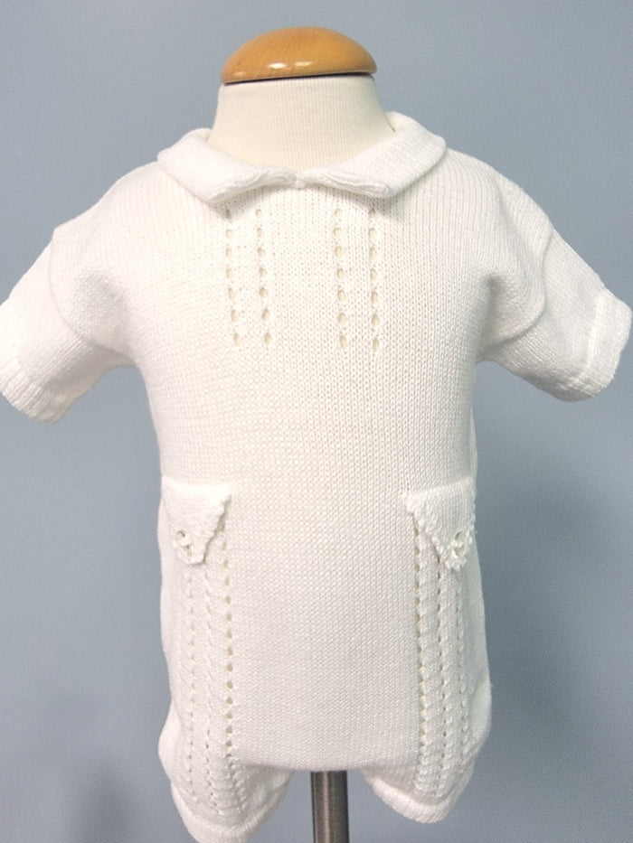White knit baby romper with decorative pockets.