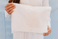 White envelope with floral embroidery.