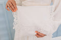 White cotton envelope with lace edges.