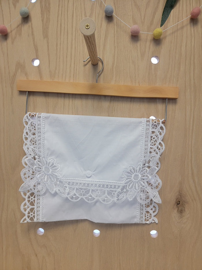 White cotton envelope with lace edges.