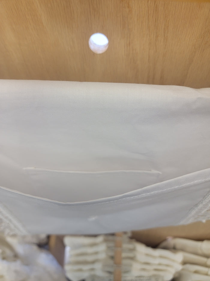 Open white cotton envelope with pocket inside.