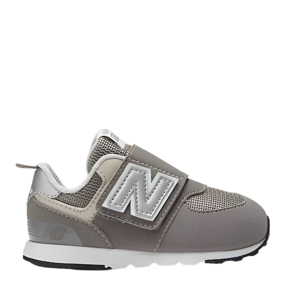 A toddler's New Balance 574 shoe with a grey synthetic/mesh upper and a hook & loop closure system.