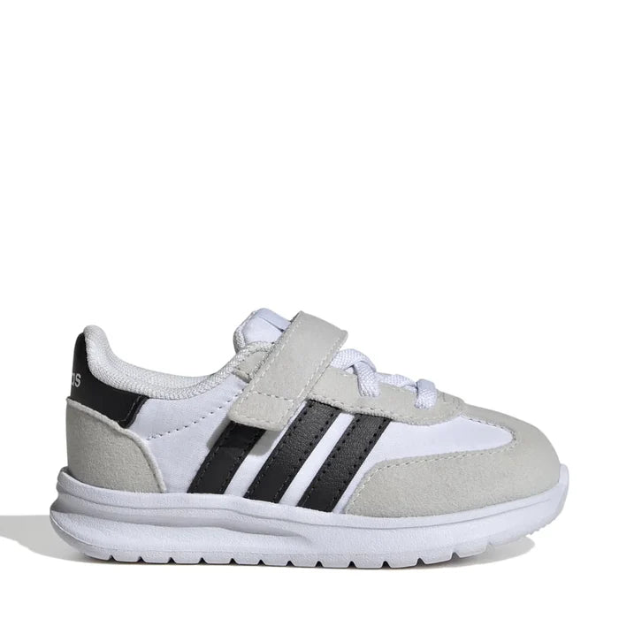 A pair of toddlers' adidas running shoes with a '70s inspired design, featuring white, black, and gray colors and a hook-and-loop strap.