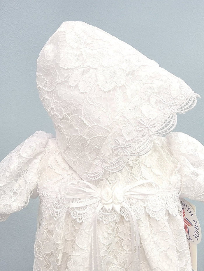 White lace baby gown with bow and bonnet.