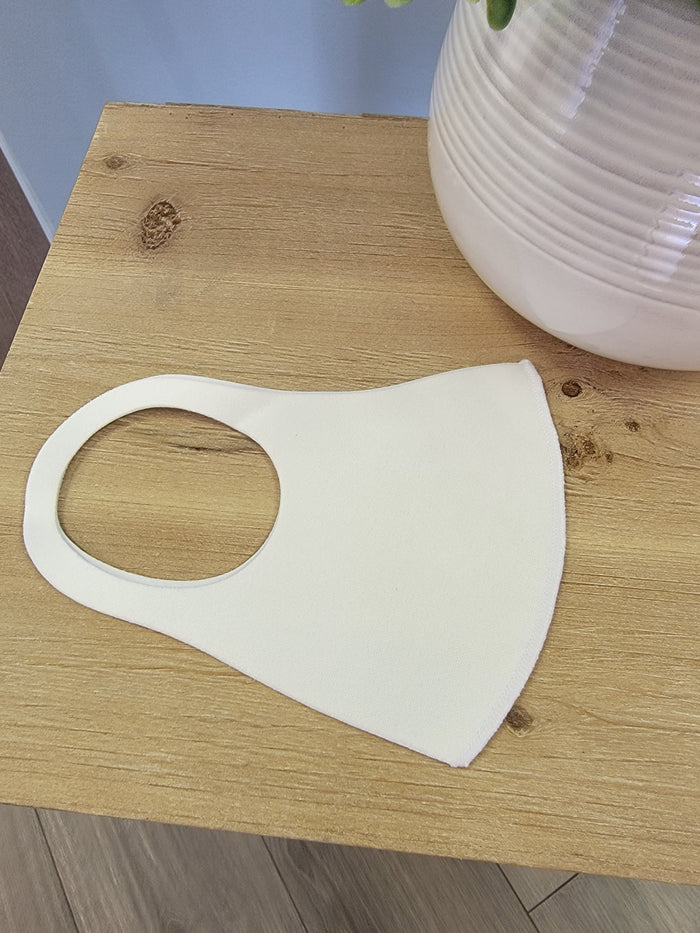 Plain white polyester face mask.