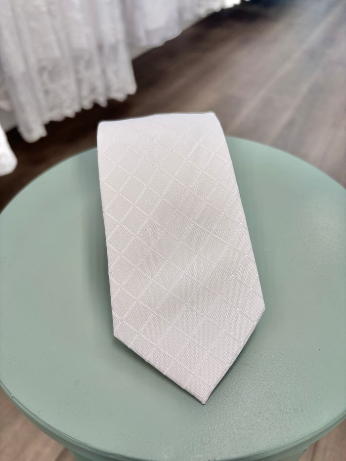 White tie with subtle square pattern.