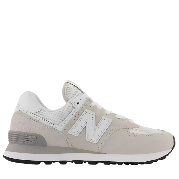 A women's New Balance 574 Core sneaker in beige color with a suede/mesh upper and a rubber outsole.