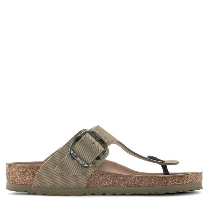 A women's thong sandal with a big buckle, featuring a textile upper in a beige color and a cork-latex footbed.