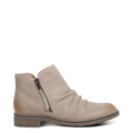 A beige women's Mila low boot with a side zipper and stretchy gore, made from genuine leather with a cork midsole and rubber outsole.