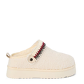 A women's slipper with faux fur lining and a tan upper with a red and white stitched band around the collar.